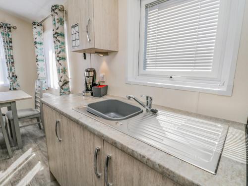 a kitchen with a sink and a window at Brighter Daze in Bridlington