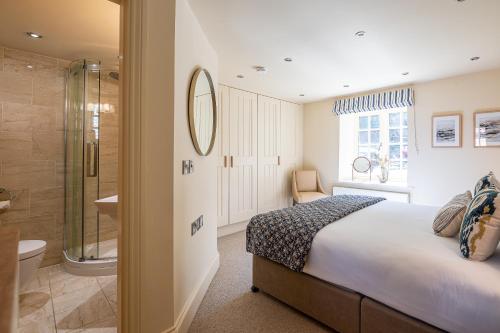 a bedroom with a bed and a shower and a bathroom at Rambling Rose in Whitby