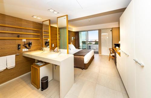 ein Bad mit einem Waschbecken und ein Bett in einem Zimmer in der Unterkunft Leonardo Boutique Hotel Mallorca Port Portals - Adults only in Portals Nous