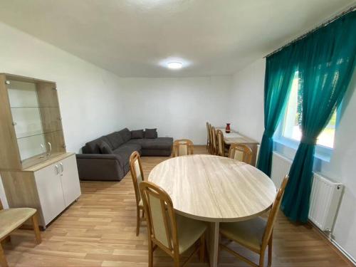 a living room with a table and a couch at The Green House - Apuseni Mountains in Pietroasa