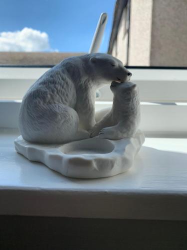 a statue of two polar bears on a window sill at Dumfries Apartment in Dumfries