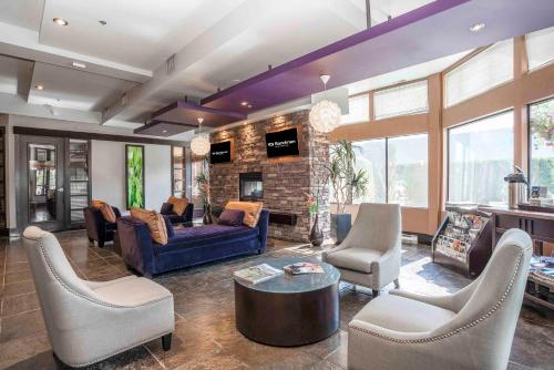 a living room filled with furniture and a fireplace at Sandman Hotel Penticton in Penticton