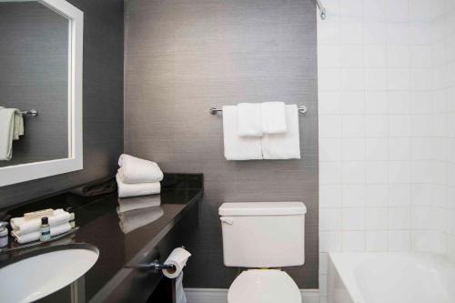 a bathroom with a white toilet and a sink at Sandman Hotel & Suites Kelowna in Kelowna