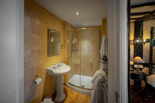 a bathroom with a sink and a shower at The White Swan Hotel Bar & Restaurant in Henley in Arden