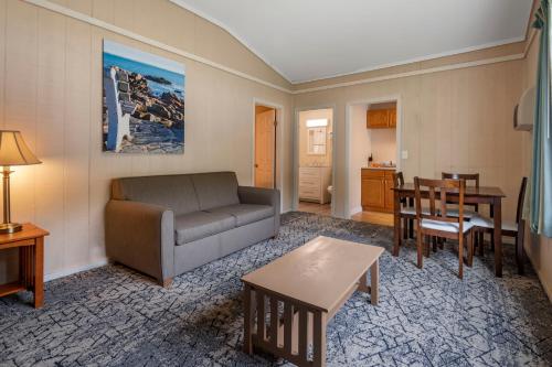 a living room with a couch and a table at Anchor Inn and Cottages Wells-Ogunquit in Wells