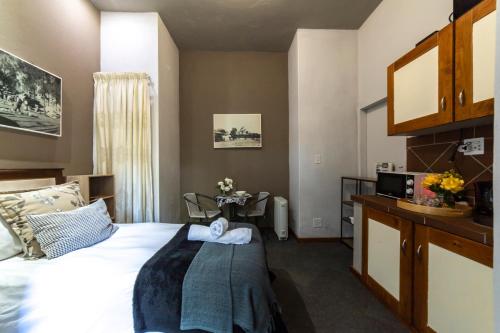 Pretoria的住宿－Craigivar Guesthouse，酒店客房配有一张床铺和一张桌子。