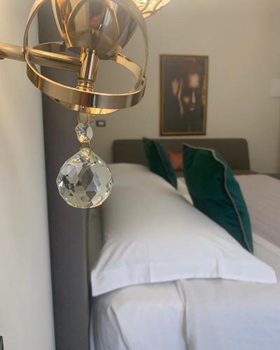 a bedroom with a bed with a chandelier above it at Amaris in Palermo