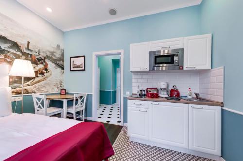 a room with a bed and a kitchen and a table at Revelton Studios Prague in Prague