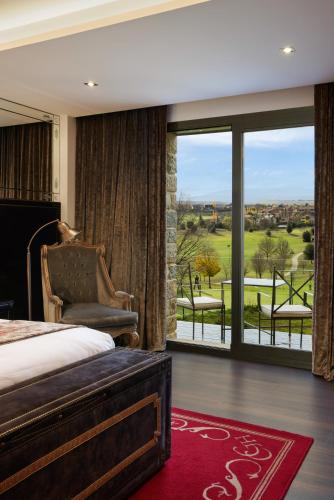 a bedroom with a bed and a window with a view at Hotel Castillo de Gorraiz&Spa in Gorraiz