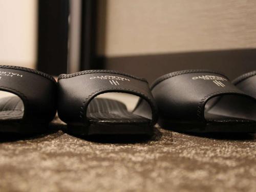 a pair of black shoes sitting on the floor at Hotel Halrotto Fukuoka Hakata in Fukuoka