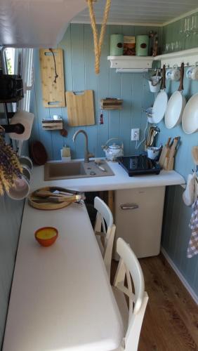 a kitchen with a counter and a sink and a table at Maringotka Na horním konci 