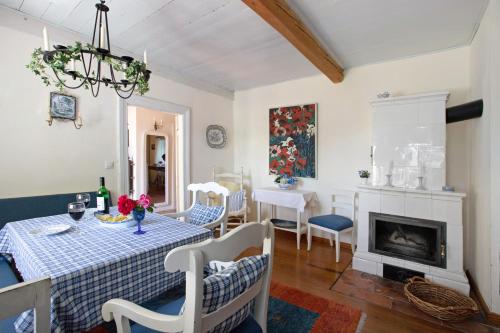 a dining room with a table and a fireplace at Pellwormhäuschen in Pellworm