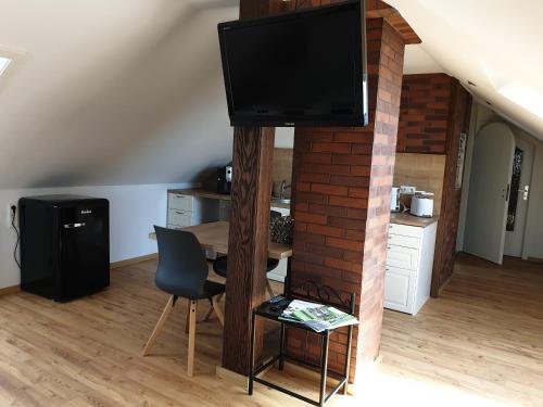 索恩堡的住宿－Apartment, Boxspringbett, ruhige Lage, Kassel Nähe，一间客厅,客厅内配有桌子和砖墙上的电视