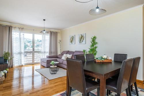 a living room with a table and a couch at My Place in Funchal by Homie in Funchal