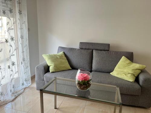 a living room with a couch and a glass table at Nuovo appartamento "Lux" in San Benedetto del Tronto