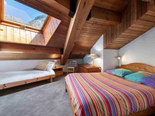 une chambre avec deux lits et une grande fenêtre dans l'établissement Duplex 3 Pièces avec Mezzanine, Centre de Val d'Isère, Proche des Pistes, Parking et Cheminée - FR-1-567-24, à Val dʼIsère