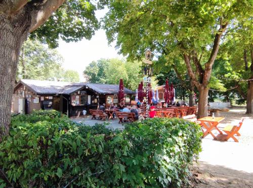 a restaurant with tables and chairs in a park at Ferienwohnung Rhöner WeitBlick in Burghaun