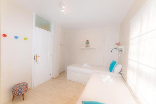 a white bathroom with a bed and a shower at La sonada bright penthouse with views in Callao Salvaje