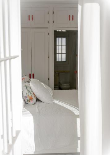 a bedroom with a bed with two pillows on it at Ático con terraza Centro Ciudad in El Puerto de Santa María