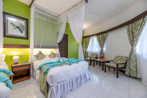 a bedroom with two beds and green walls at Safari Beach Hotel in Diani Beach