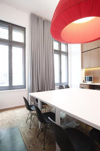a dining room with a white table and chairs at Hotel C2 in Marseille