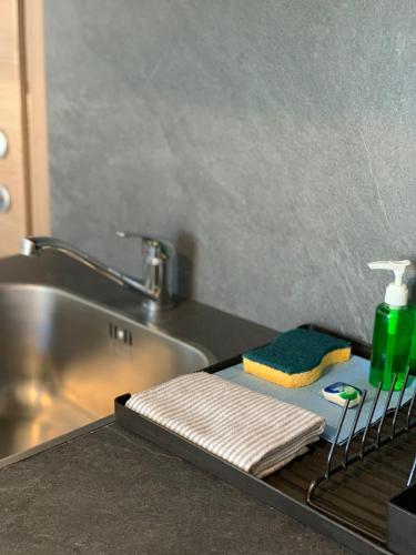 a bathroom with a sink and a towel on a drying rack at Ai Suma Residence in Bormio