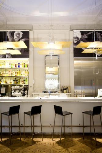 a bar in a restaurant with four stools at Hotel C2 in Marseille