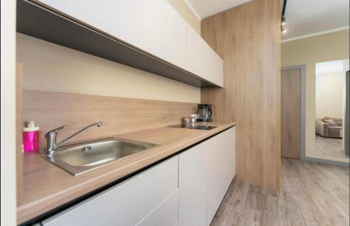 a kitchen with a sink and a wooden counter top at Bel Mare E504 in Międzyzdroje