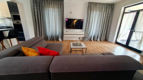 a living room with a couch and a tv at CasaNova in Sînmartin
