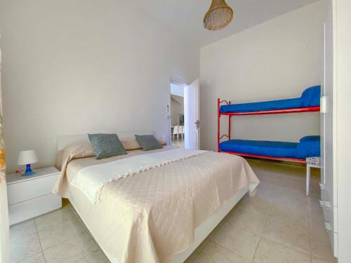 a white bedroom with a bed and a mirror at Villa Pace by BarbarHouse in Torre Lapillo