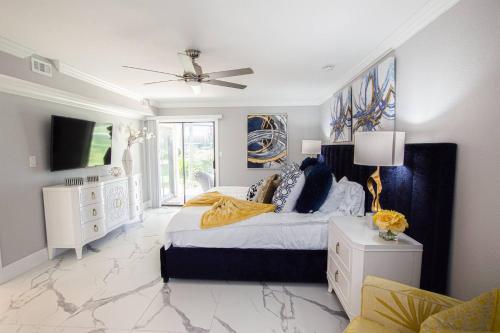 a bedroom with a king sized bed and a tv at Lavish Living ~ Ground Floor Corner Unit in Wesley Chapel
