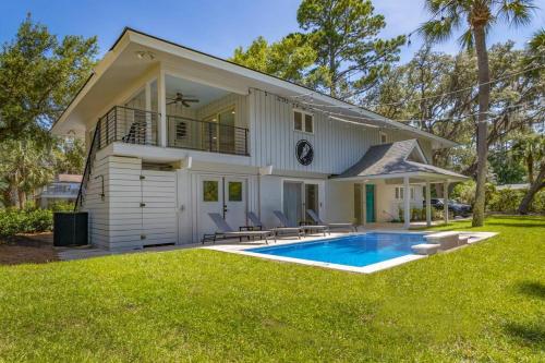 a house with a swimming pool in the yard at Luxury Beach House - 2min Walk to Beach - Private Pool - Group & Dog Friendly in Hilton Head Island