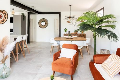 une salle à manger et un salon avec une table et des chaises dans l'établissement L'Oursinade - Jolie maison avec Jacuzzi et jardin, à Bandol