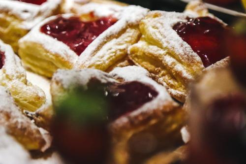 a close up of a plate of food with powdered sugar at Borjomi Bridge Hotel in Borjomi