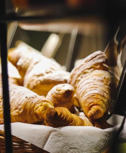 a bunch of croissants are sitting in a basket at Borjomi Bridge Hotel in Borjomi