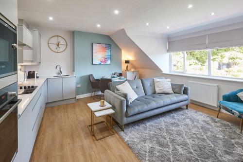 a living room with a couch and a kitchen at Host & Stay - The Loft @ The Regency in Harrogate