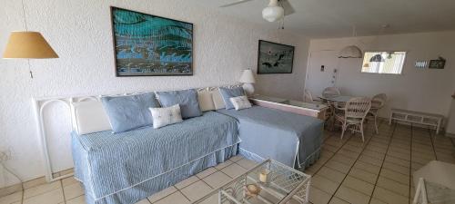 a bedroom with a bed and a table in it at Sapphire Village Condos in St Thomas