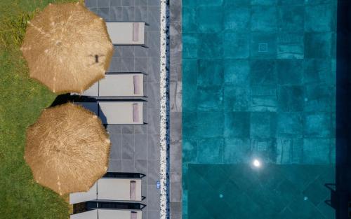 an overhead view of a swimming pool next to houses at Sonel Luxury Villa, a Family Retreat, By ThinkVilla in Mouzákion