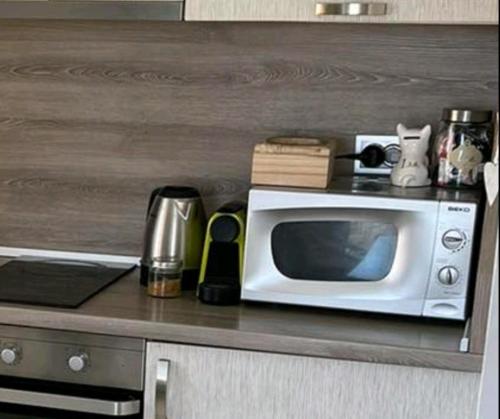 a microwave sitting on top of a kitchen counter at Sweety in Sliven
