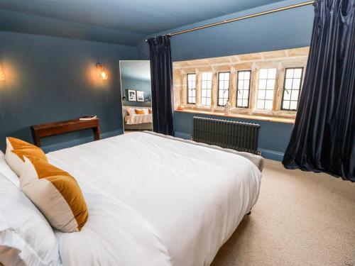 a bedroom with a large white bed and a window at Warley Lodge in Halifax