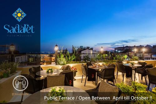 a restaurant with tables and chairs on a balcony at night at Sadaret Hotel&Suites Istanbul -Best Group Hotels in Istanbul