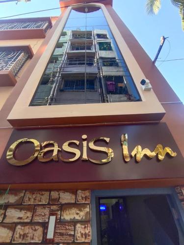 a sign on the front of a restaurant at OASIS INN in Baharampur
