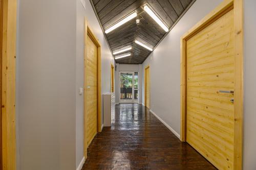 a hallway with wooden doors and a wooden ceiling at Blend Mountain Villa in Buşteni