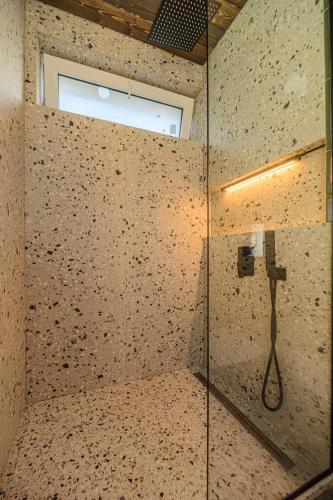 a bathroom with a shower with a glass wall at Blend Mountain Villa in Buşteni