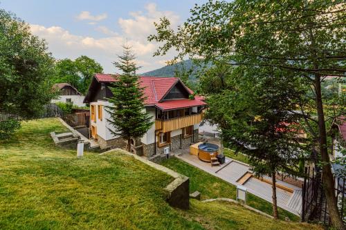 an aerial view of a house with a yard at Blend Mountain Villa in Buşteni
