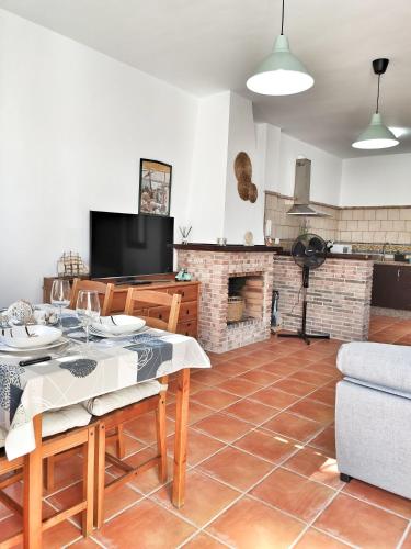 a living room with a table and a fireplace at El Jándalo in Benaocaz