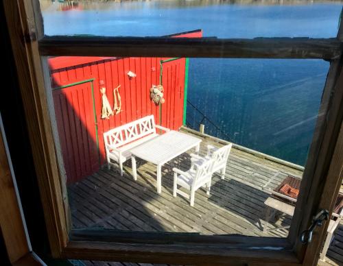 a view of a table and two chairs on a dock at Skjæret rorbu in Stamsund
