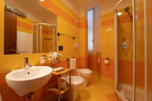 a bathroom with a sink and a toilet and a shower at il passetto in Rome