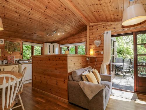 a living room and kitchen in a log cabin at Scafell Lodge in Windermere