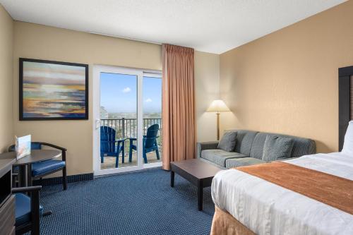 a hotel room with a bed and a balcony at Crystal Beach Hotel in Ocean City